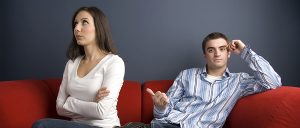 Young couple arguing on sofa